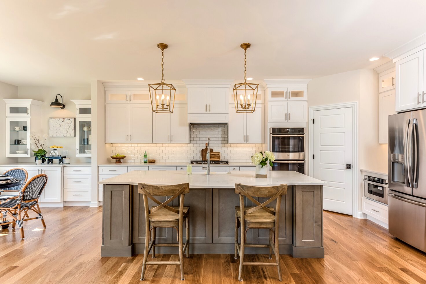 Two pendant lights hang over kitchen island