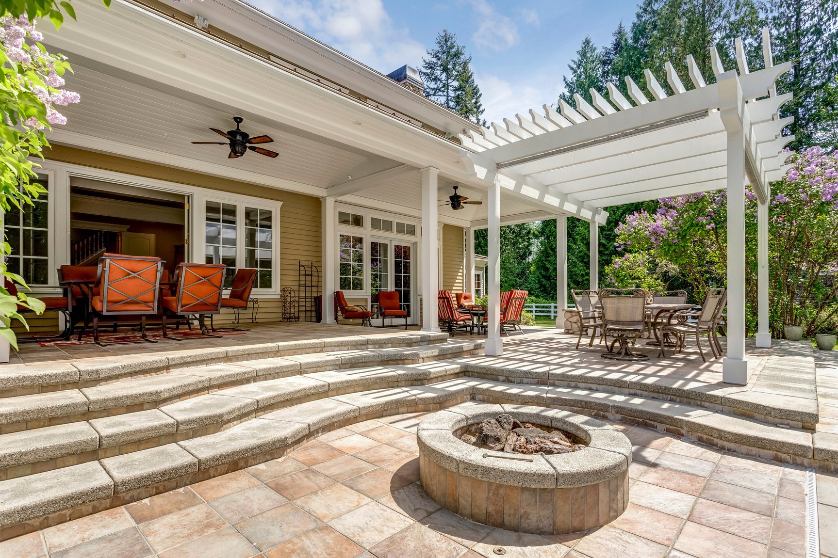 Lovely outdoor deck patio space with white dining pergola.